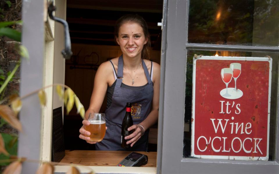 A beer served through the window at the Duke of Cumberland Arms in West Sussex - Julian Simmonds/The Telegraph