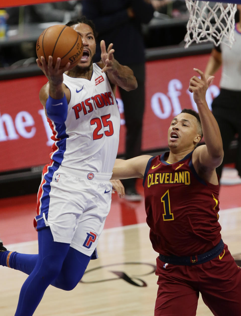 Detroit Pistons guard Derrick Rose, left, goes to the basket past Cleveland Cavaliers guard Dante Exum, right, during the first half of an NBA basketball game Saturday, Dec. 26, 2020, in Detroit. (AP Photo/Duane Burleson)