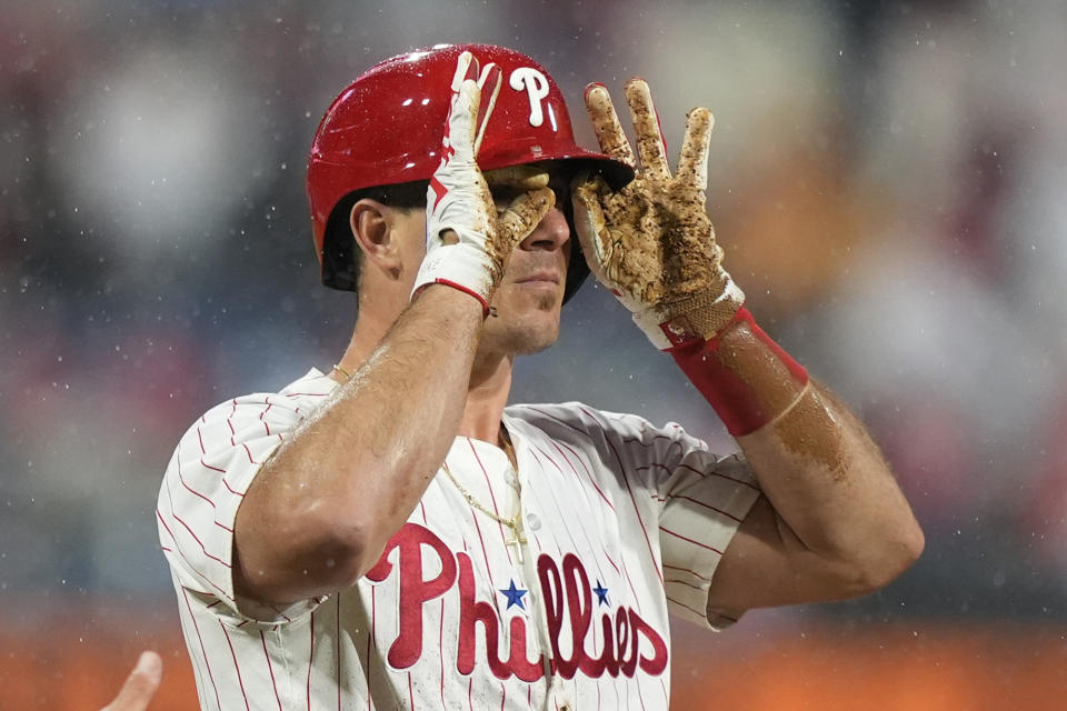 Philadelphia Phillies' J.T. Realmuto reacts after hitting a triple against San Francisco Giants pitcher Mitch White during the second inning of a baseball game, Saturday, May 4, 2024, in Philadelphia. (AP Photo/Matt Slocum)