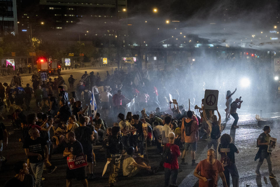 Police use water cannon to disperse demonstrators during a protest against Israeli Prime Minister Benjamin Netanyahu's government, and calling for the release of hostages held in the Gaza Strip by the Hamas militant group, in Tel Aviv, Israel, Saturday, May 25, 2024. (AP Photo/Ariel Schalit)