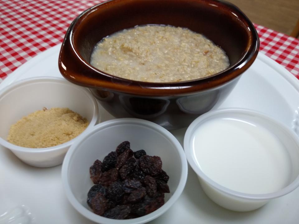 Hot oatmeal is served with brown sugar, raisins and milk at Horseshoe Diner in Ravenna.
