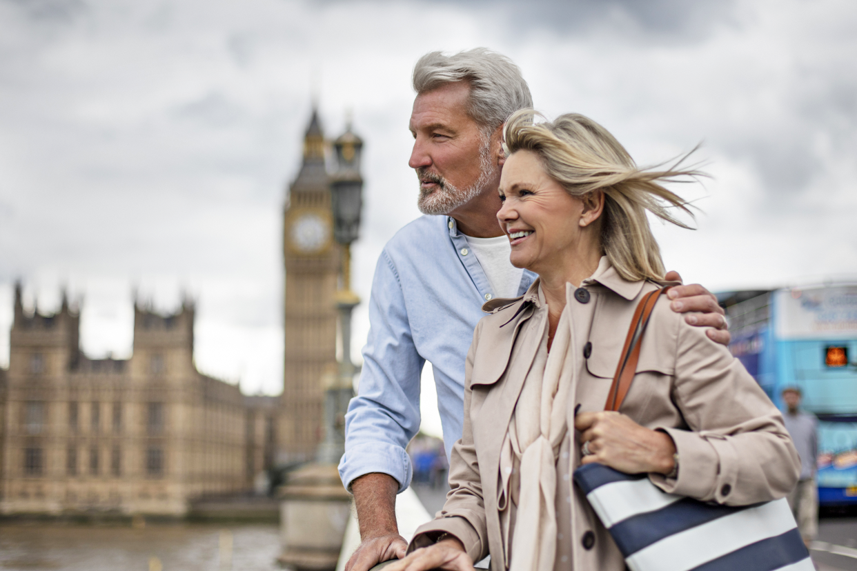 Couple standing on a bridge in London on a cloudy day