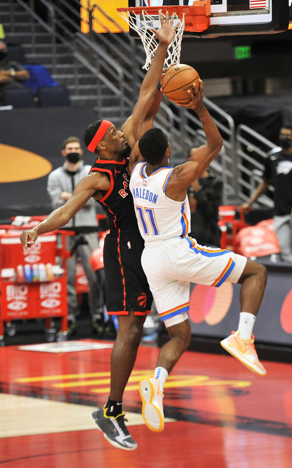 Toronto Raptors' Paul Watson defends Oklahoma City Thunder's Theo Maledon (11) during the first quarter of a basketball game Sunday, April 18, 2021, in St. Petersburg, Fla. (AP Photo/Steve Nesius)