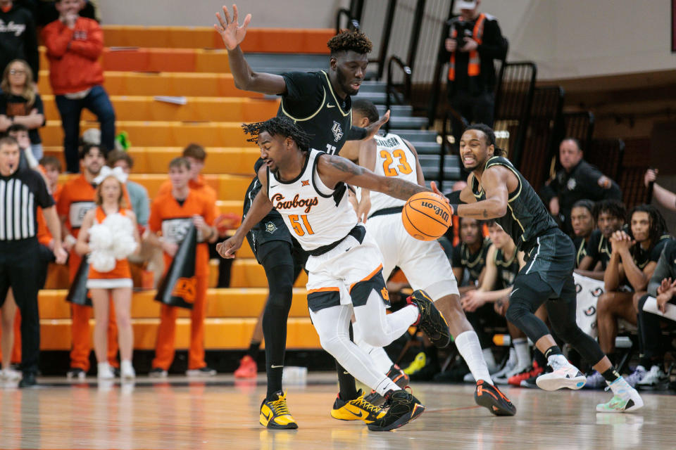 Feb 28, 2024; Stillwater, Oklahoma, USA; Oklahoma State Cowboys guard John-Michael Wright (51) drives around UCF Knights forward Ibrahima Diallo (11) during the first half at Gallagher-Iba Arena. Mandatory Credit: William Purnell-USA TODAY Sports