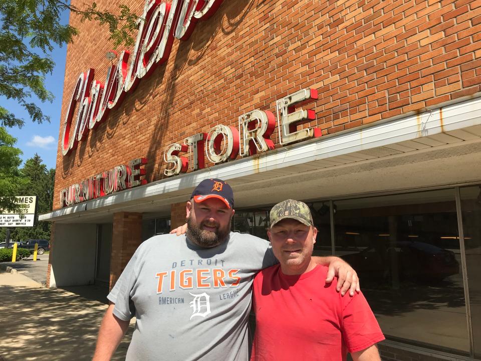 Matt Milcher (left) and Roland Holifield in front of the former Christensen’s Home Furnishings store, turned family-owned resale store, Way Too Cheap, in 2019.