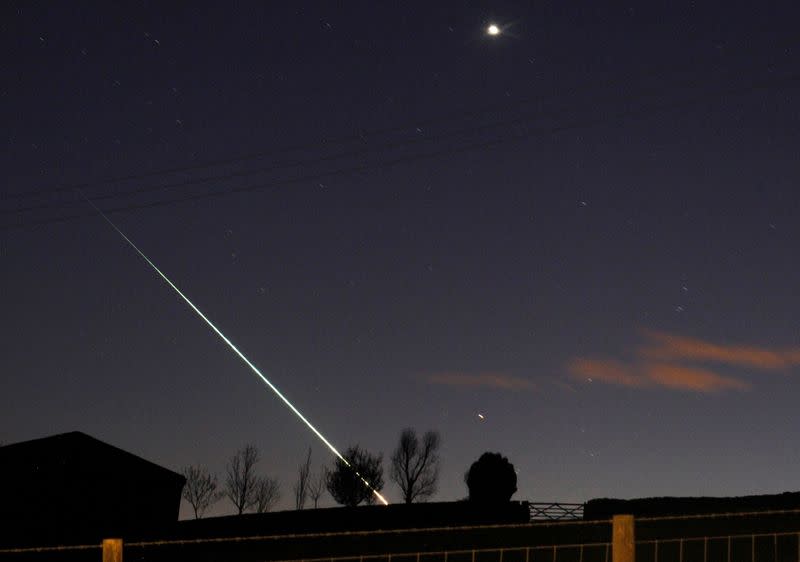 FILE PHOTO: A meteorite creates a streak of light across the night sky over the North Yorkshire moors at Leaholm, near Whitby, northern England