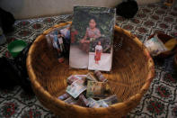 A basket is seen with banknotes and pictures of Claudia Gomez, a 19-year old Guatemalan immigrant who was shot by an U.S. Border Patrol officer, at her home in San Juan Ostuncalco, Guatemala May 27, 2018. REUTERS/Luis Echeverria