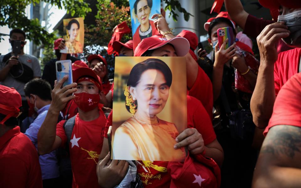 Protesters hold up images of Myanmar's leader Aung San Suu Kyi at a protest outside its embassy in Bangkok, Thailand - Lauren DeCicca/Getty