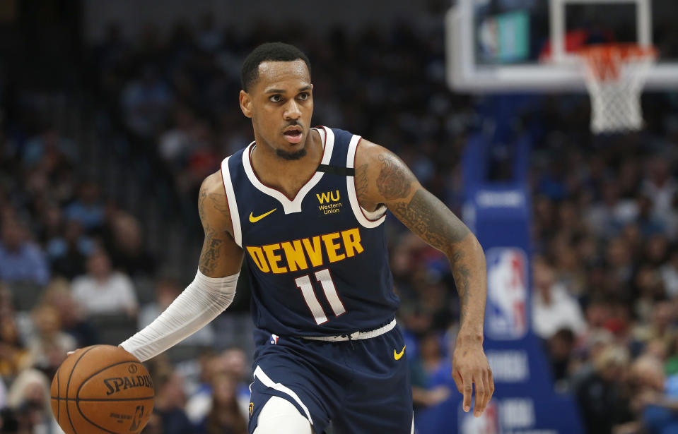 Denver Nuggets guard Monte Morris (11) brings the ball upcourt against the Dallas Mavericks during the first half of an NBA basketball game Wednesday, March 11, 2020, in Dallas. (AP Photo/Ron Jenkins)