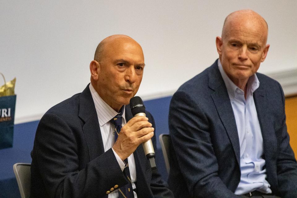 Ocean State Job Lot CFO John Conforti, left, addresses students during a University of Rhode Island panel discussion of CFOs on April 1. At right is Textron CFO Frank Connor.