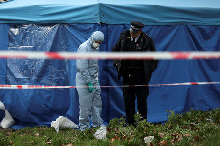 A forensic officer talks to a policeman outside a forensics tent at a property where the body of Laureline Garcia-Bertaux was found in Kew, London, Britain March 7, 2019. REUTERS/Simon Dawson