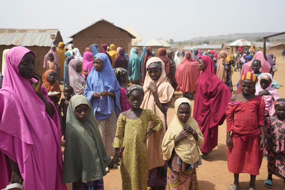 People wait for news about the kidnapped LEA Primary and Secondary School Kuriga students in Kuriga, Kaduna, Nigeria, Saturday, March 9, 2024. Security forces swept through large forests in Nigeria's northwest region on Friday in search of nearly 300 children who were abducted from their school a day earlier in the West African nation's latest mass kidnap which analysts and activists blamed on the failure of intelligence and slow security response. (AP Photo/Sunday Alamba)