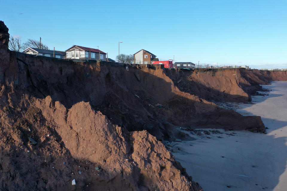 WITHERNSEA, UNITED KINGDOM - JANUARY 09:  Holiday chalets abandoned due to coastal erosion wait to be demolished or taken by the sea in the village of Withersea in the East Riding of Yorkshire on January 09, 2020 in Withernsea, United Kingdom. The effects of global warming and climate change creating storms and sea swells have seen the East Coast of the United Kingdom lose up to one metre of coast line each year.  Landslips and cliff falls caused by waterlogged land and sea erosion has claimed hundreds of roads, homes and holiday accommodation. (Photo by Christopher Furlong/Getty Images)