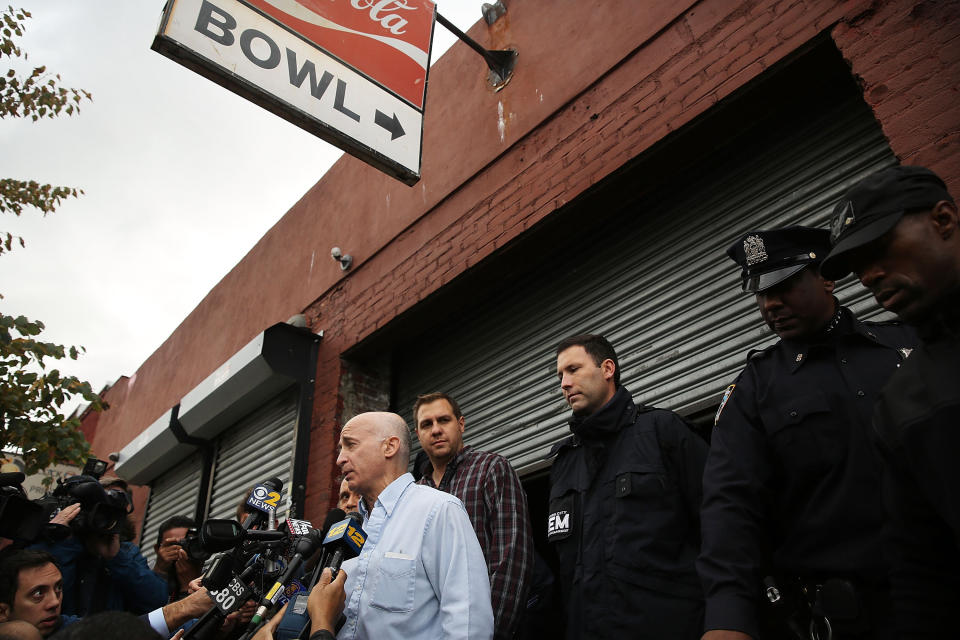 Don Weiss, from the NYC Department of Health and Mental Hygiene, speaks to the media in front of the closed Brooklyn bowling alley that New York City's first Ebola patient visited before showing symptoms of the virus.