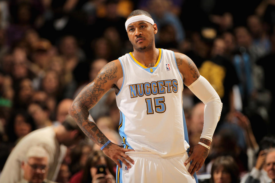 DENVER, CO - JANUARY 21:  Carmelo Anthony #15 of the Denver Nuggets looks on during a break in the action against the Los Angeles Lakers at the Pepsi Center on January 21, 2011 in Denver, Colorado. The Lakers defeated the Nuggets 107-97. NOTE TO USER: User expressly acknowledges and agrees that, by downloading and or using this photograph, User is consenting to the terms and conditions of the Getty Images License Agreement.  (Photo by Doug Pensinger/Getty Images)