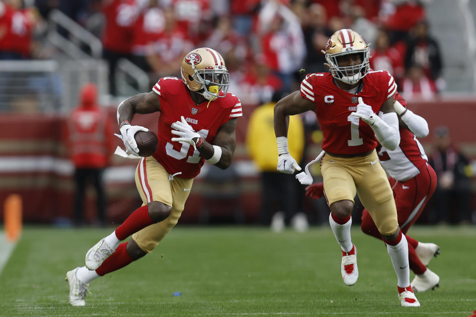 San Francisco 49ers safety Tashaun Gipson Sr., left, returns an interception next to cornerback Jimmie Ward (1) during the second half of an NFL football game against the Arizona Cardinals in Santa Clara, Calif., Sunday, Jan. 8, 2023. (AP Photo/Jed Jacobsohn)