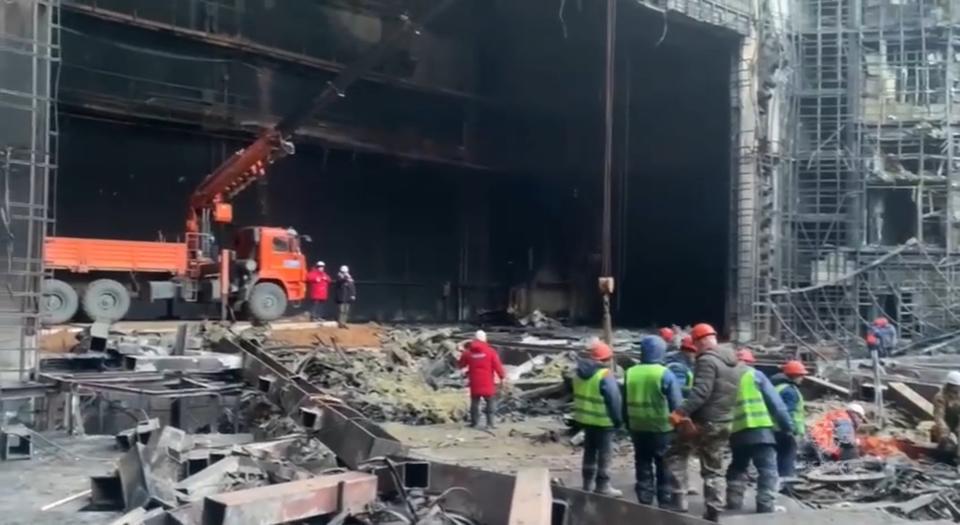 In this photo taken from video released by Russian Emergency Ministry Press Service on Tuesday, March 26, 2024, rescuers work in the burned concert hall after a terrorists attack on the building of the Crocus City Hall on the western edge of Moscow, Russia. Russia is still reeling from the attack Friday in which gunmen killed 139 people in the Crocus City Hall, a concert venue on the outskirts of Moscow. Health officials said about 90 people remain hospitalized, with 22 of them, including two children, in grave condition. (Russian Emergency Ministry Press Service via AP)
