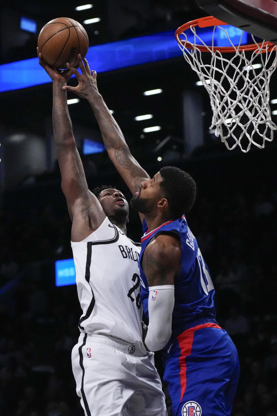 LA Clippers' Paul George (13) blocks a shot by Brooklyn Nets' Dorian Finney-Smith (28) during the first half of an NBA basketball game Wednesday, Nov. 8, 2023, in New York. (AP Photo/Frank Franklin II)