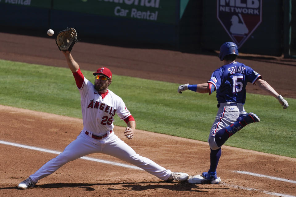 Texas Rangers' Nick Solak (15) is safe at first base before a catch by Los Angeles Angels' Jared Walsh (25) during the second inning of a baseball game Monday, Sept. 21, 2020, in Anaheim, Calif. (AP Photo/Ashley Landis)