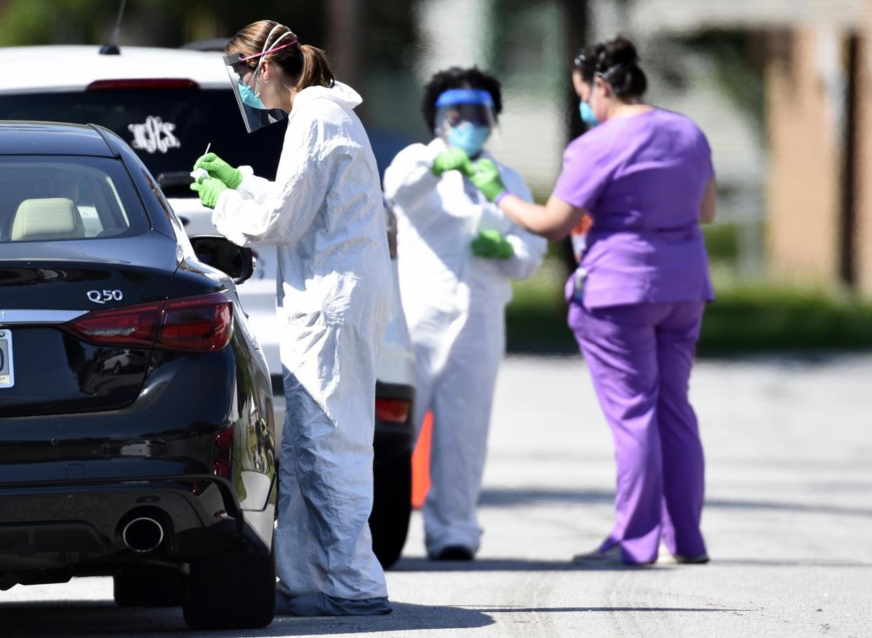 Medical workers get samples during drive-up COVID-19 testing in Augusta, Ga., in June 2020. Georgia ranked 34th among the states where coronavirus was spreading the fastest on a per-person basis, a USA TODAY Network analysis of Johns Hopkins University data shows.