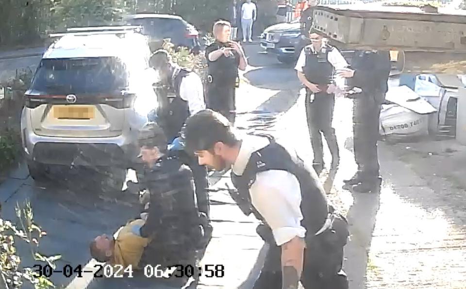 Police officers detaining a sword-wielding man in Hainault (Jordan Pettitt/PA Wire)