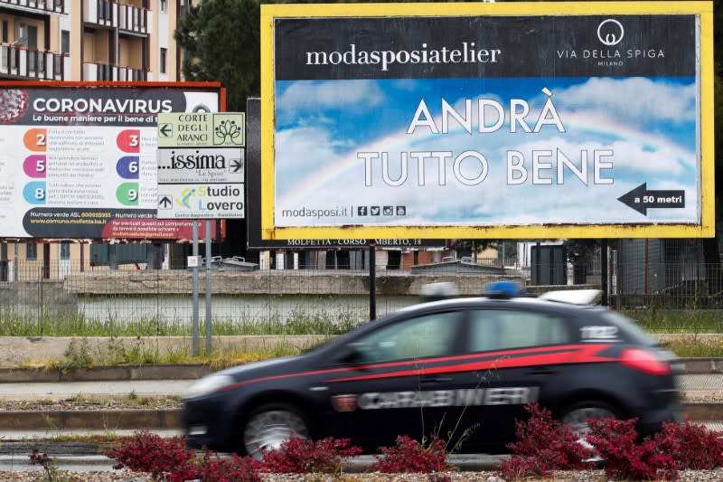 A car drives past a sign reading "Everything's gonna be okay" as the spread of the coronavirus disease (COVID-19) continues, in Molfetta