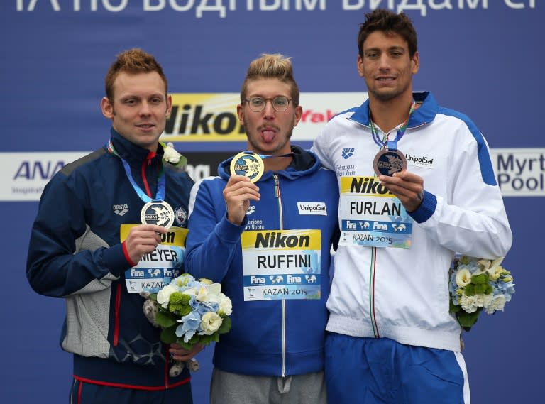 Gold medalist Simone Ruffini of Italy (C) poses with silver medalist Alex Meyer of the US (L) and bronze medalist Matteo Furlan of Italy during the medal ceremony for the Men's 25km Open Water Swimming Final in Kazan, Russia, August 1, 2015