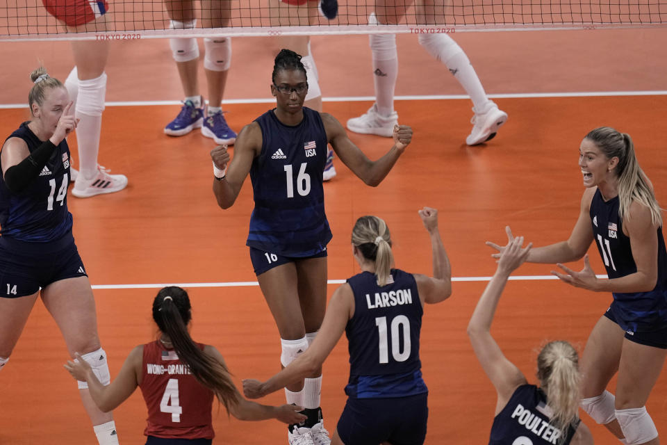 United States players celebrate winning a point during the women's volleyball semifinal match between Serbia and United States at the 2020 Summer Olympics, Friday, Aug. 6, 2021, in Tokyo, Japan. (AP Photo/Manu Fernandez)