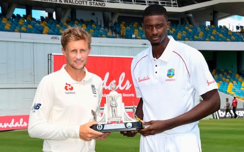 Captains Joe Root (left) and Jason Holder (right) with the Wisden trophy - Credit: afp