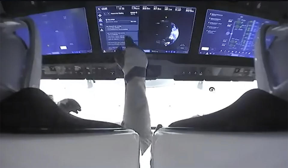 In this image made from NASA video, astronauts are seen in the cockpit of the SpaceX Crew Dragon spacecraft after lift off for the Crew-2 mission from Launch Complex 39A, Friday, April 23, 2021, at the Kennedy Space Center in Cape Canaveral, Fla. (NASA via AP)