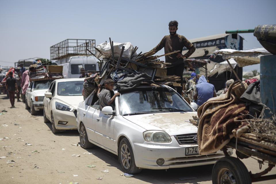 Palestinians arrive in the southern Gaza town of Khan Younis after fleeing an Israeli ground and air offensive in the nearby city of Rafah on Friday, June 28, 2024. (AP Photo/Jehad Alshrafi)