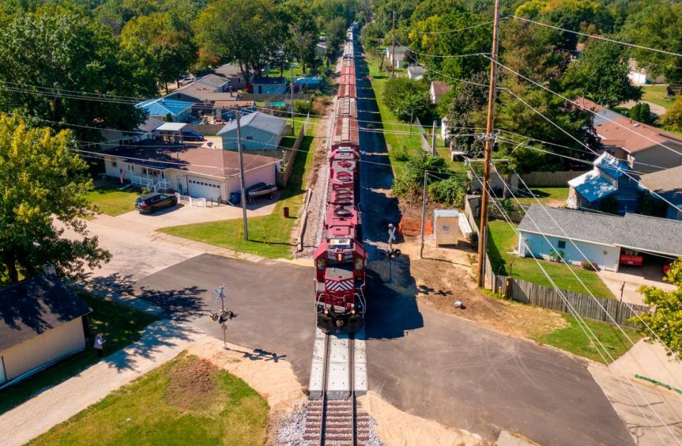 A Canadian Pacific freight train rolls through one of seven railroad crossings on Wednesday, Sept. 28, 2022, in Camanche, Iowa. A merger of Kansas City Southern and Canadian Pacific railways will increase train traffic and length of trains traveling through the town, potential blocking rail crossing for extended periods of time.