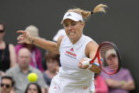 Germany's Angelique Kerber plays a return to Aliaksandra Sasnovich of Belarus during the women's singles third round match on day six of the Wimbledon Tennis Championships in London, Saturday July 3, 2021. (AP Photo/Kirsty Wigglesworth)