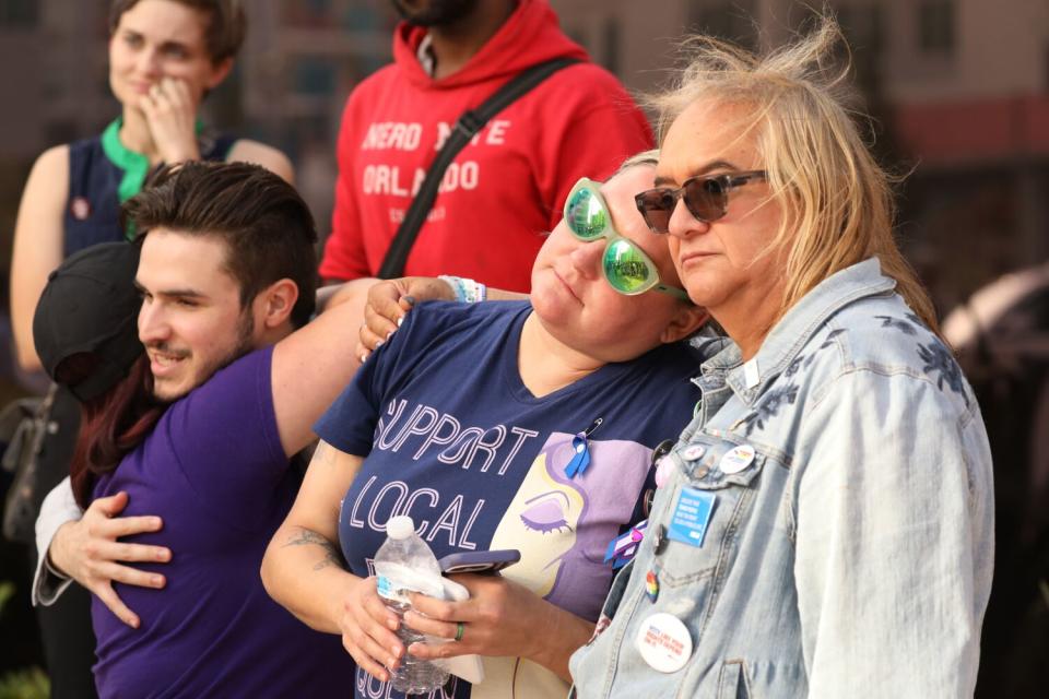 Jen Cousins, center, co-founded the Florida Freedom to Read Project, gets a hug during a protest for LGBTQ rights.