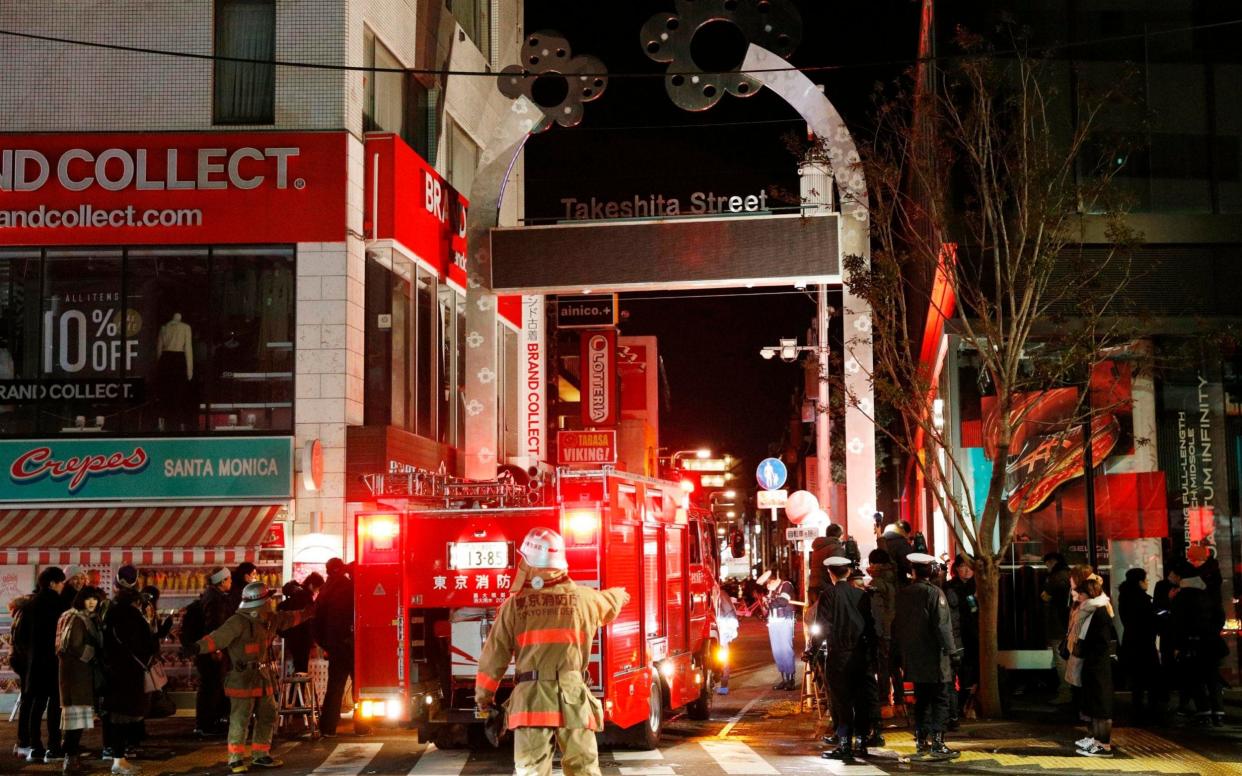 Police and firefighters inspect around the site of a car attack near Takeshita Street in Tokyo, - Kyodo News