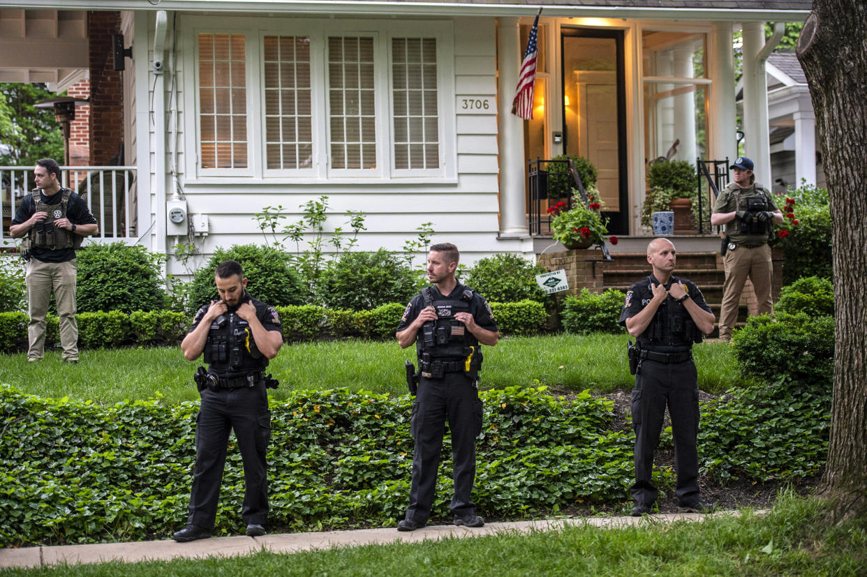 Police officers stand outside the home of U.S. Supreme Court Justice Brett Kavanaugh in anticipation of an abortion-rights demonstration on May 18, 2022 in Chevy Chase, Md. (Bonnie Cash / Getty Images file)