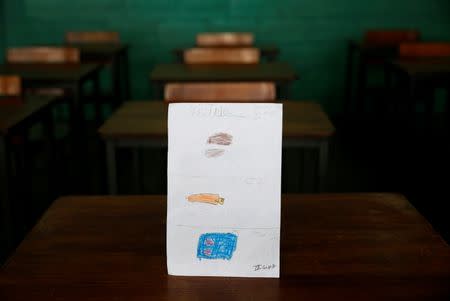 A drawing made during a lesson at a school shows what a student ate during the course of a day in Caracas, Venezuela July 14, 2016. The student wrote, "For breakfast, lunch and dinner I had corn cake with cheese." Picture taken July 14, 2016. REUTERS/Carlos Jasso