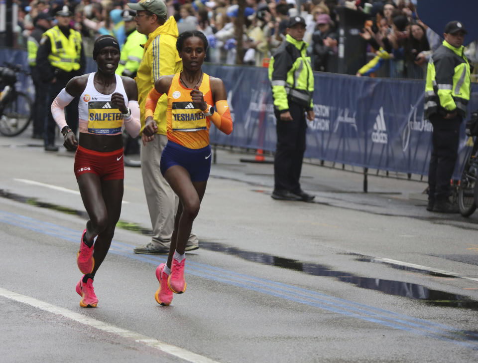 Lonah Salpeter, of Israel, and Ababel Yeshaneh, of Ethiopia, race to the finish of the 127th Boston Marathon, Monday April 17, 2023, in Boston. Salpeter finished third and Yeshaneh fourth in the women's division. (AP Photo/Jennifer McDermott)