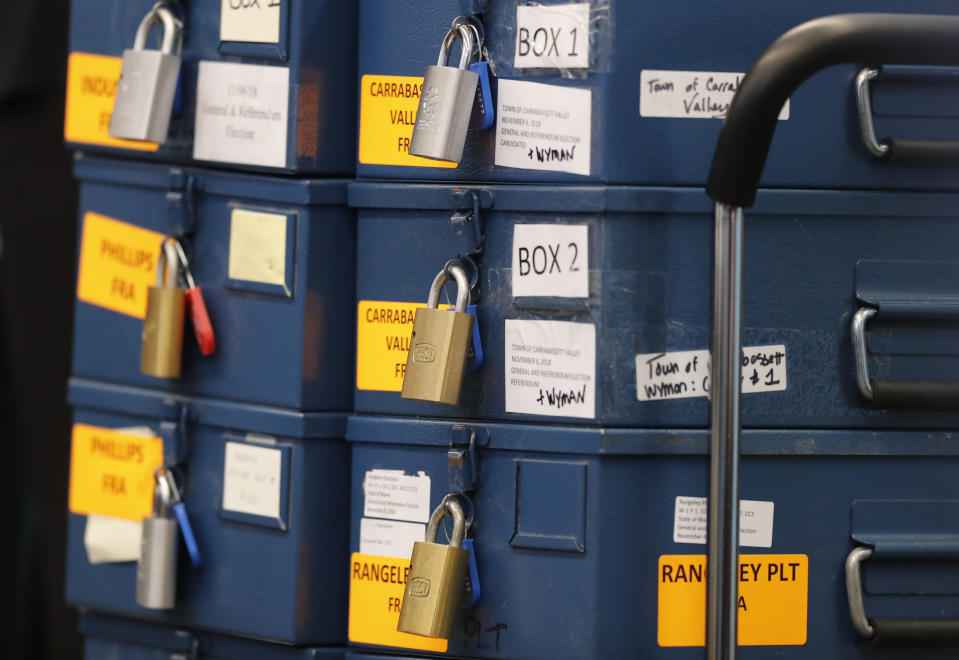 Locked ballot boxes await opening during the vote tabulation process for Maine's Second Congressional District's House election Monday, Nov. 12, 2018, in Augusta, Maine. The election is the first congressional race in American history to be decided by the ranked-choice voting method that allows second choices. (AP Photo/Robert F. Bukaty)