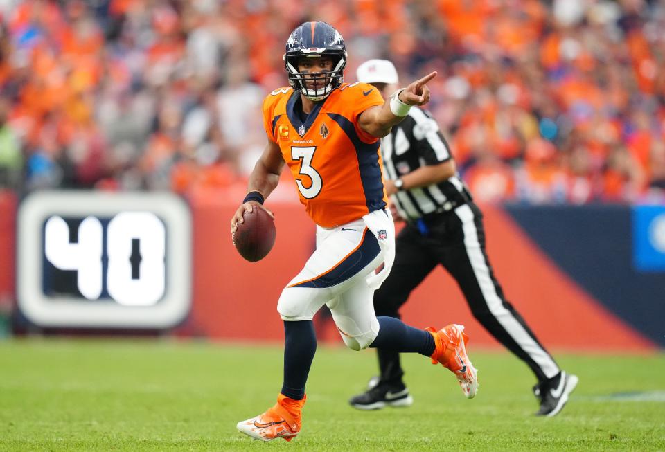 Denver Broncos quarterback Russell Wilson (3) scrambles with the ball in the third quarter against the Las Vegas Raiders at Empower Field at Mile High.