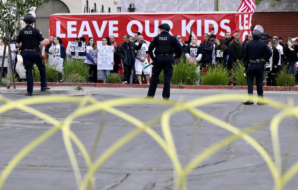 Conservative groups and LGBTQ+ rights supporters protest as police try to maintain order outside the Glendale Unified School District offices in Glendale, California.