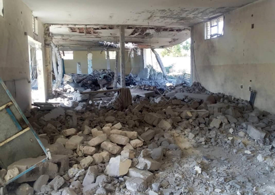 This image taken on a mobile phone on Wednesday July 3, 2019 shows the damage inside the detention center in Tripoli's Tajoura neighborhood after an airstrike. Libyan officials say an airstrike has struck a detention center for migrants in the capital, killing at least 40 people and wounding dozens. The airstrike was likely to raise further concerns about the European Union's policy of partnering with Libyan militias to prevent migrants from crossing the Mediterranean, which often leaves them at the mercy of brutal traffickers or stranded in squalid detention centers near the front lines. (AP Photo)