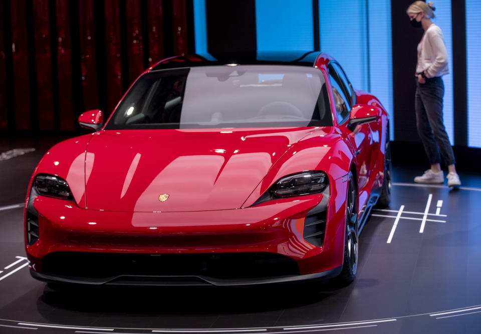 Los Angeles, CA - November 19:  An automotive enthusiast views the world premier of the Porsche Taycan GTS Sport Tourismo during the LA Auto Shows opening day at Los Angeles Convention Center in Los Angeles, CA on Friday, Nov. 19, 2021. (Allen J. Schaben / Los Angeles Times via Getty Images)