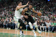 Boston Celtics forward Grant Williams (12) defends as Milwaukee Bucks forward Giannis Antetokounmpo (34) drives toward the basket during the first half of Game 7 of an NBA basketball Eastern Conference semifinals playoff series, Sunday, May 15, 2022, in Boston. (AP Photo/Steven Senne)