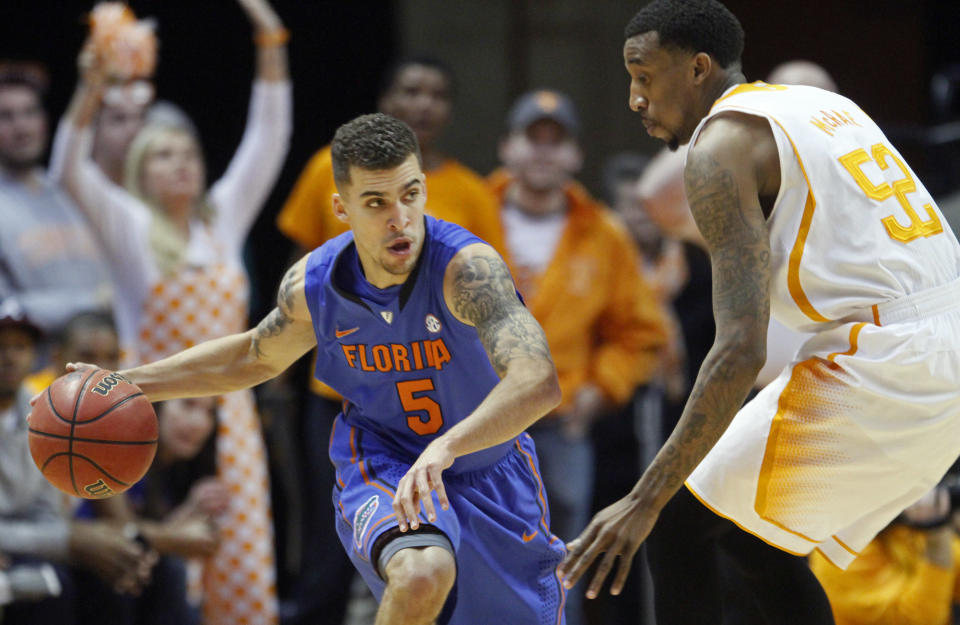 Florida guard Scottie Wilbekin (5) drives against Tennessee guard Jordan McRae (52) in the first half of an NCAA college basketball game on Tuesday, Feb. 11, 2014, in Knoxville, Tenn. (AP Photo/Wade Payne)