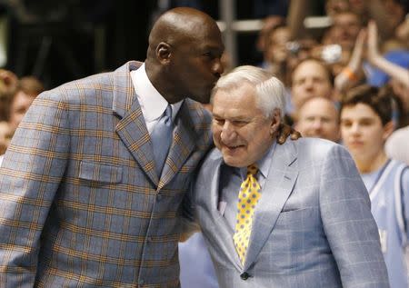 Former University of North Carolina player and NBA standout Michael Jordan (L) kisses former University of North Carolina head coach Dean Smith during a ceremony honoring the 1957 and 1982 national championship teams at halftime of the NCAA basketball game between North Carolina and Wake Forest University in Chapel Hill, North Carolina, in this file photo taken February 10, 2007. REUTERS/Ellen Ozier/Files