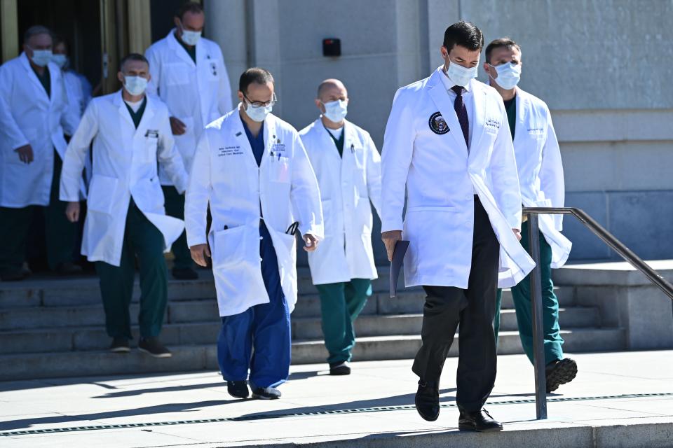 White House physician Sean Conley (2nd R), with medical staff, arrives to give an update on the condition of US President Donald Trump, on October 3, 2020, at Walter Reed Medical Center in Bethesda, Maryland. - Trump was hospitalized on October 2 due to a Covid-19 diagnosis. (Photo by Brendan SMIALOWSKI / AFP) (Photo by BRENDAN SMIALOWSKI/AFP via Getty Images)