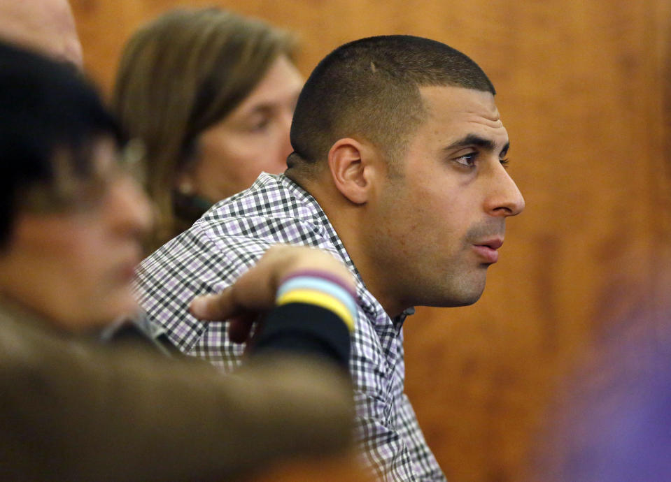 FILE - Dennis Hernandez, brother of former New England Patriots NFL football player Aaron Hernandez, watches during his brother's murder trial on Jan. 29, 2015, in Fall River, Mass. Former UConn football player Dennis Hernandez is behind bars after a witness told police she believed he was planning a school shooting. The 37-year-old, who went by DJ while playing for the Huskies as a quarterback and receiver in the mid-2000s, is due in court on Aug. 1 on charges including threatening. (AP Photo/Steven Senne, Pool, File)