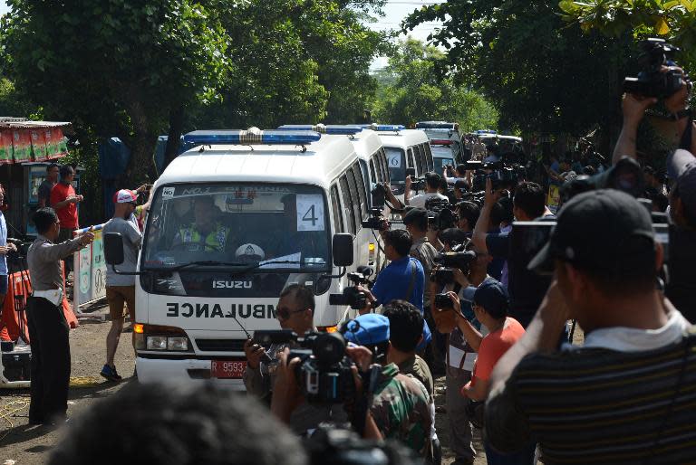 A convoy of ambulances carrying coffins arrives in Nusakambangan port in Cilacap located across from Nusakambangan maximum security prison island on April 28, 2015