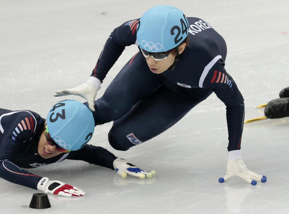 Sin Da-woon of South Korea, left, crashes as Lee Han-bin of South Korea goes down with him in a men's 1500m short track speedskating semifinal at the Iceberg Skating Palace during the 2014 Winter Olympics, Monday, Feb. 10, 2014, in Sochi, Russia. (AP Photo/Ivan Sekretarev)